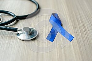 Colon Cancer Awareness, dark blue Ribbon with stethoscope for supporting people living photo