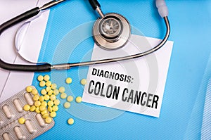 Colon cancer words written on medical blue folder photo