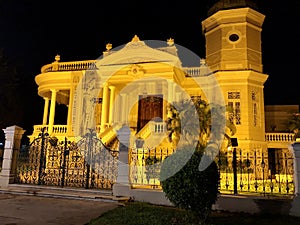 Colonial and ancient museum, seen from the front at night, illuminated with yellow lights
