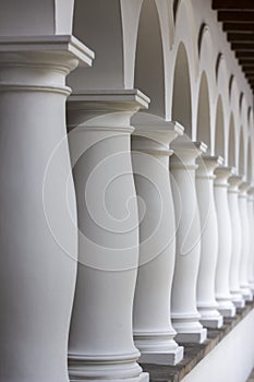 Colonial architectural details in Quito, white columns aligned i