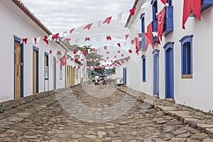 A colonial architecture street in Paraty, adorned with flags for the traditional Divine Holy Spirit Festivity. Brazil.