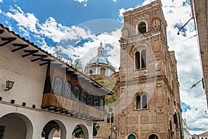 Colonial building with balcony and Cathedral in Cuenca, Ecuador photo