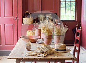 Colonial hat makers workbench with a hat and tools