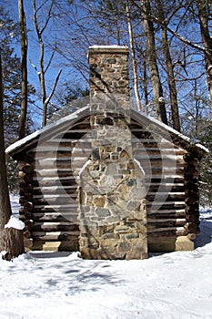 Colonial Log Cabin in Snow