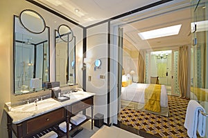 Colonial stye hotel room with classic bathroom design and elegant bedroom