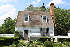 Colonial style house with garden against blue sky