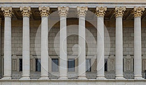 A colonnade of a public law court. A neoclassical building with a row of corinthian columns.