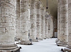 Colonnade with snow in St. Peter's Basilica.