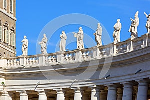 Colonnade on St.Peter`s Square, statues of saints on the top, Vatican, Rome, Italy