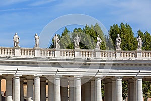 Colonnade on St.Peter`s Square, statues of saints on the top, Vatican, Rome, Italy