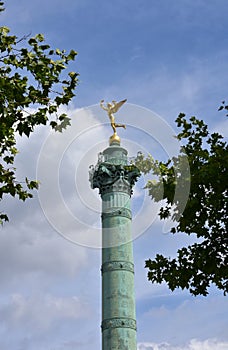 Colonne de Juillet at Place de la Bastille. Gilded statue Genie de la Liberte close-up. Paris, France.