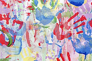 Color background of children`s handprints. Multi colored hand prints