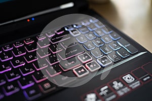 Color backlit keyboard close up. Gaming laptop.