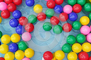 Color balls in swimming pool with water flat lay