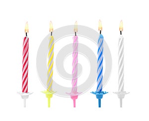 Color birthday cake candles on white