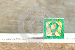 Color block in question mark sign on wood background