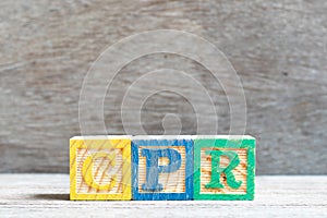 Color block in word CPR abbreviation of Cardiopulmonary resuscitation on wood background