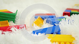 Color blocks toys lie on a white background close-up. Camera slider movement.