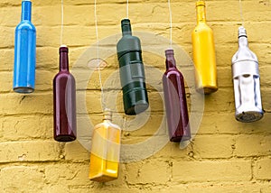 Color bottles , background of a yellow brick wall.