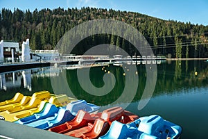 Color catamarans in lake in Carpathian mountains