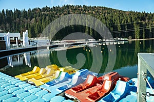 Color catamarans in lake in Carpathian mountains