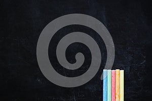 Color chalks on black board background