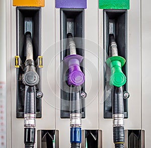 Colour coded petrol pump nozzles photo
