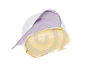 Color corrector strokes isolated on white background. Yellow and lilac color correcting cream concealer smudge photo