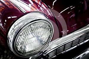 Color detail on the headlight of a vintage car.