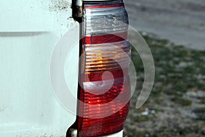 color dirty taillight on a white car