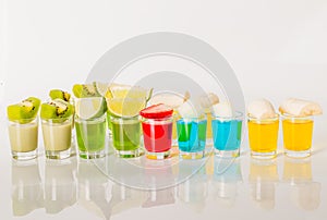 Color drinks in shot glass, blue, green, red, yellow and creamy