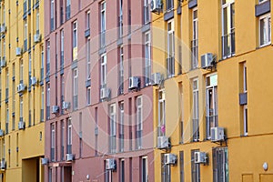 Color facade of a house with lot of air condition units.