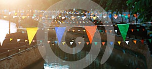 Color flag, colorful bunting flags against a blue saturated sky,