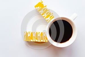 Color glazed cakes and coffee cup on white background