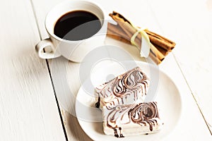 Color glazed cakes and coffee cup on white background.