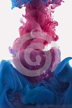 Color ink drop in water. redish violet, deep blue photo