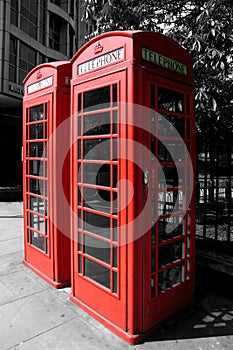 Color isolated red phone booths in London