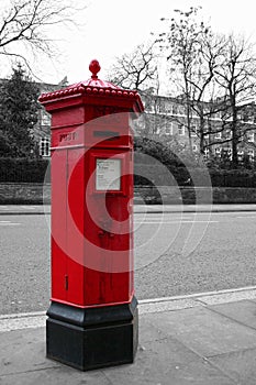 Color isolated Victorian hexagonal red post box of the Penfold type in London