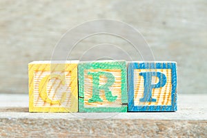 Color letter block in word CRP abbreviation of C-Reactive Protein Test on wood background