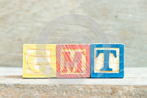 Color letter block in word GMT abbreviation of Greenwich Mean Time on wood background