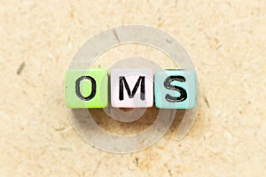 Color letter block in word OMS Abbreviation of Order management system or Operations management system on wood