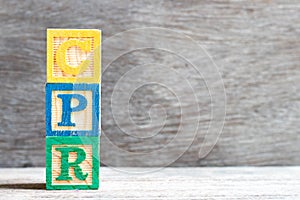 Color letter in word CPR abbreviation of Cardiopulmonary resuscitation on wood background