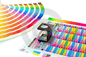 Color management in printing process with magnifying glass and paint guide.