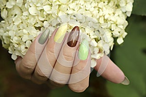 Color manicure with pastel and pearl nail polishes