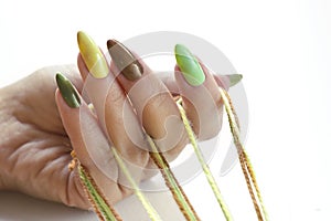 Color manicure with pastel and pearl nail polishes photo