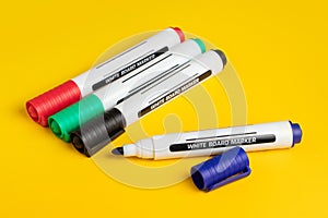 Color markers on yellow background. Close up