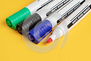 Color markers on yellow background. Close up
