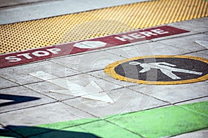 Color marking of pedestrian crossing with symbols and inscriptions