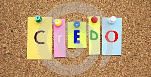 Color notes with letters pinned on a board. Word CREDO. photo