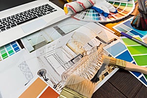 Color  palette for design home renovation. Apartaments sketch with sampler laptop and brush at desk